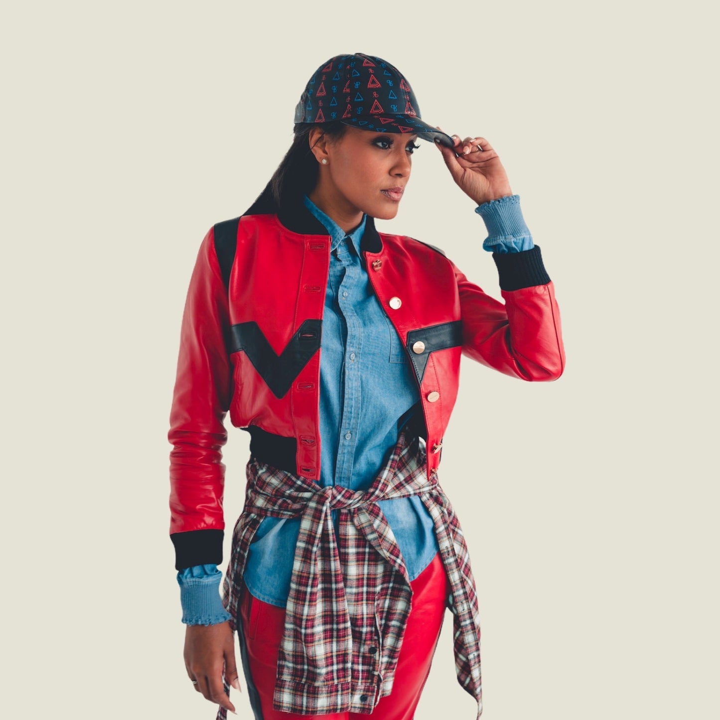 The Cropped Valley Bomber by PRSVR.  Red and Black Colorway on female model Sheba. Pyramid Hat by PRSVR 